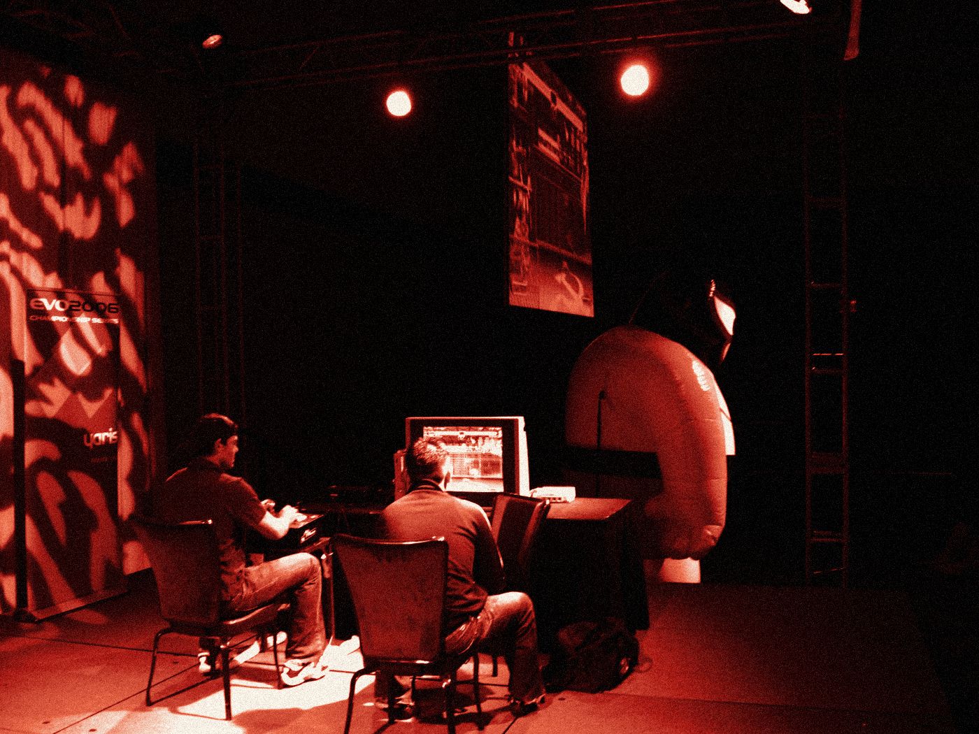 Two players at the machine under stage lights